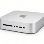 Silver Apple Mac mini with the Apple logo on top, photographed on a white background, used to illustrate the Mac mini RAM apocalypse and higher 2026 prices.