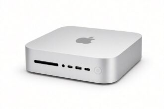 Silver Apple Mac mini with the Apple logo on top, photographed on a white background, used to illustrate the Mac mini RAM apocalypse and higher 2026 prices.