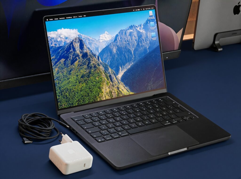 MacBook Air M5 vs Windows Laptops 2026 Buyer's Guide, dark blue desk.

